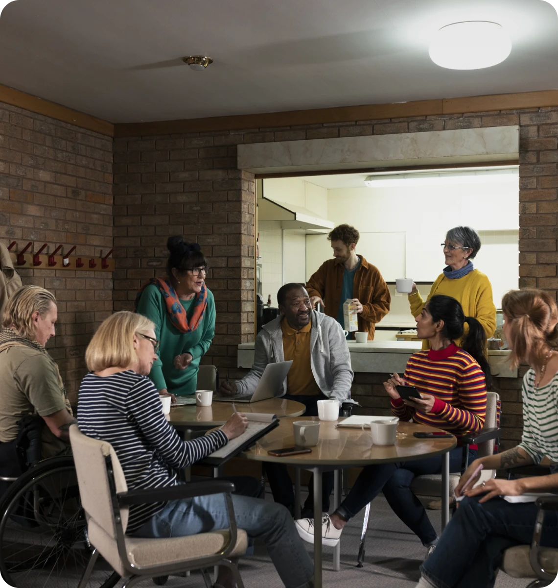 A group of people gathered around a table in a casual setting.